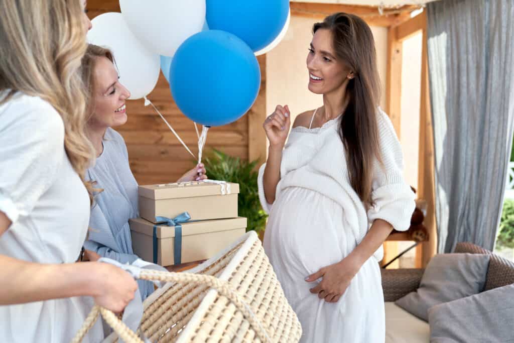 women at a baby shower with gifts and balloons