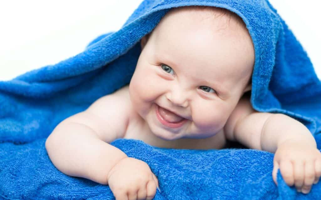 baby smiling in towel